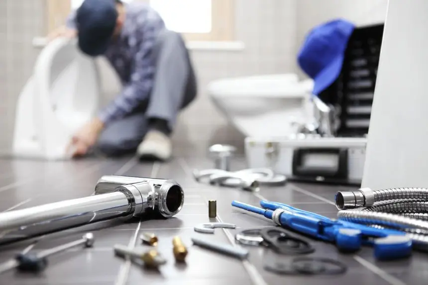 Plumber at work in a bathroom